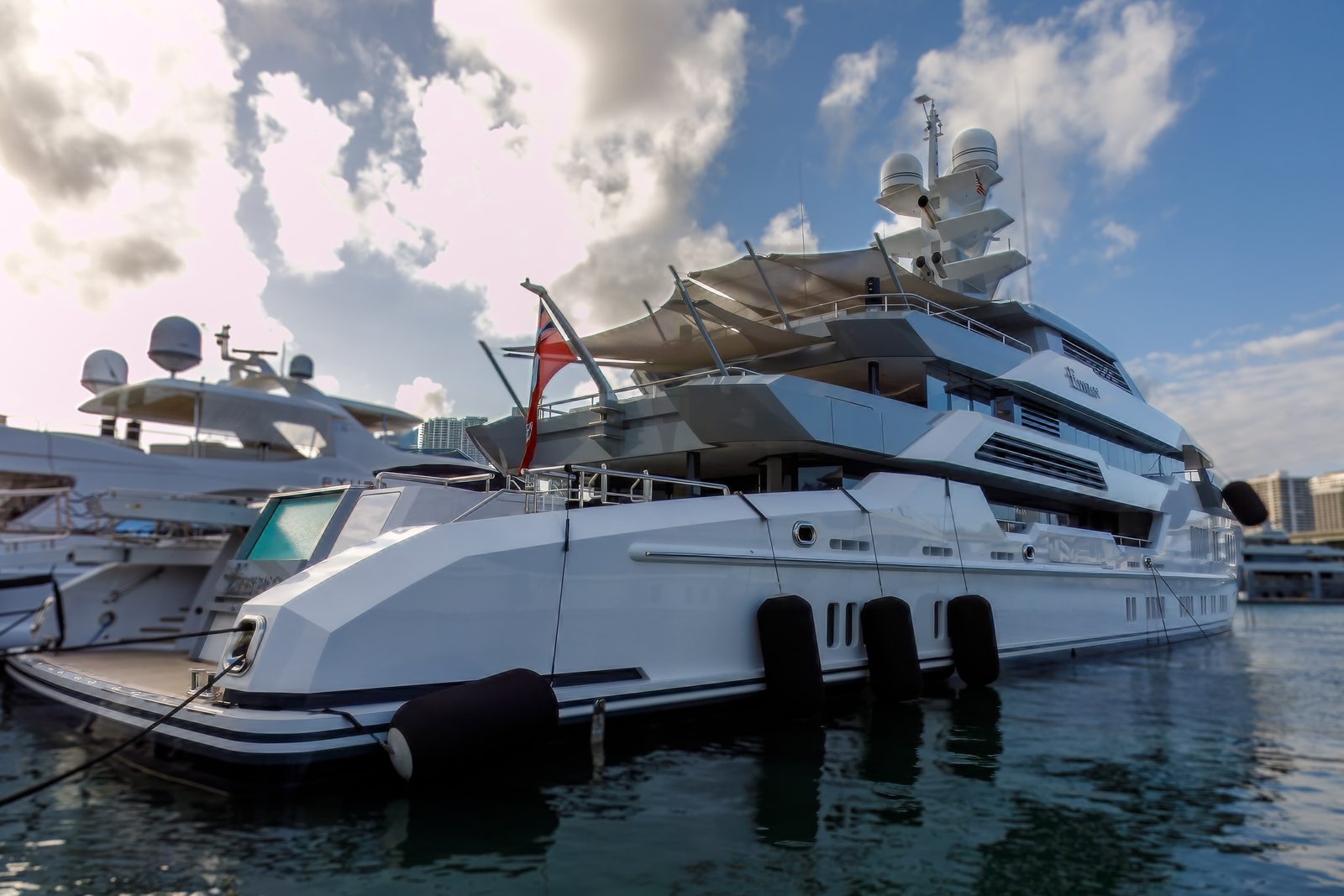 Superyacht docked at a downtown Miami marina with the skyline behind